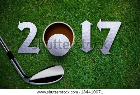 Happy New Golf year 2017,  Golf ball and putter on green grass.