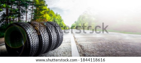 Change a car seasonal tyre summer forest road with trees background. Change for winter tire. Banner Selling off. Or Background automechanic  Royalty-Free Stock Photo #1844118616
