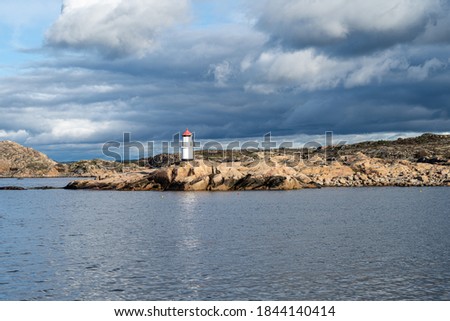 A beautiful lighthouse outside a fishing village on the Swedish Atlantic coast. Picture from Hamburgsund, Vastra Gotaland, Sweden