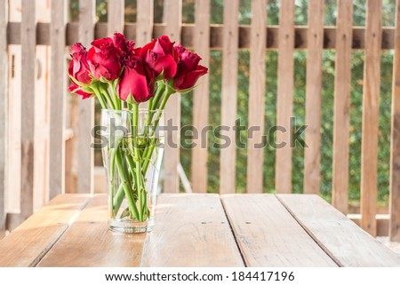 Group of red roses on wooden table, stock photo