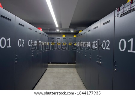 changing room for factory workers hard hat on numbered cabinets Royalty-Free Stock Photo #1844177935