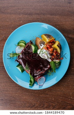 beef ribs in BBQ sauce with grilled vegetables