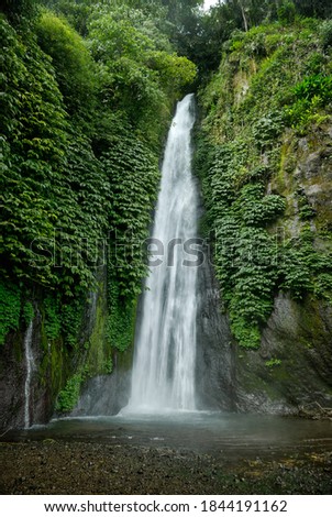 Waterfall within green tropical jungle Royalty-Free Stock Photo #1844191162