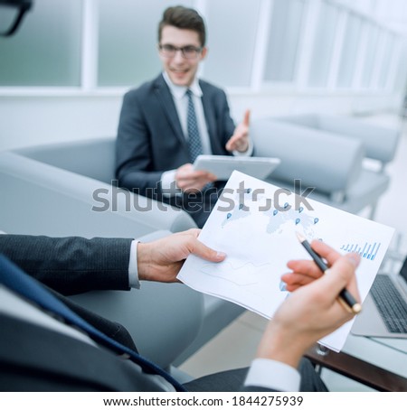 close up.the businessman analyzes the business document