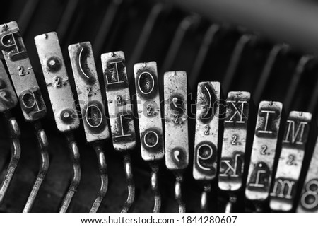 details of typewriter hammers showing various letters, numbers and symbols