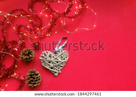 Bright red Christmas flat lay with decorations, garland and wooden decorative heart, family celebrations concept with copy space for your design or text