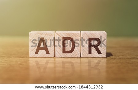 ADR (abbreviation for Adverse Drug Reaction) word written on wooden blocks on a wooden table. Medical concept. Royalty-Free Stock Photo #1844312932