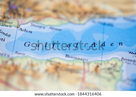 Shallow depth of field focus on geographical map location of Gulf of Aden off coast of Yemen on atlas Royalty-Free Stock Photo #1844316406