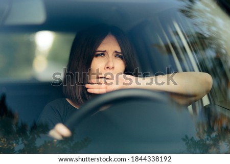 Sleepy Female Driver Yawning Behind the Wheel Royalty-Free Stock Photo #1844338192