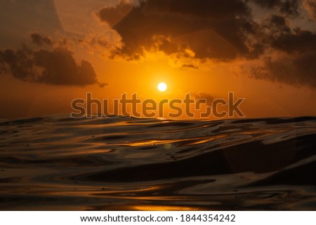 Golden sunset in Indian Ocean, pictured from the water in Bali