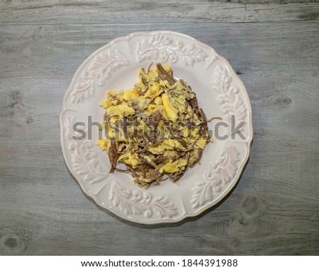 Top view of machaca con huevos or shredded beef with eggs, a traditional Mexican breakfast.