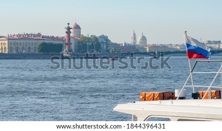 Cityscape, embankment in Saint Petersburg, Russia, view of the Neva river, boat with the Russian flag