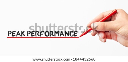 Hand writing PEAK PERFORMANCE with red marker. Isolated on white background. Business, technology, internet concept. Stock Image