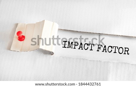 The text IMPACT FACTOR appearing behind torn yellow paper
