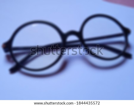 blur image of round sunglasses isolated white color screen