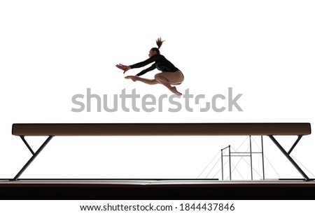 Female gymnast doing a complicated trick isolated on white.