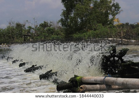 
a fast moving waterwheel in the river
