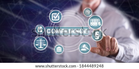 Man touching a compliance concept on a touch screen with his finger