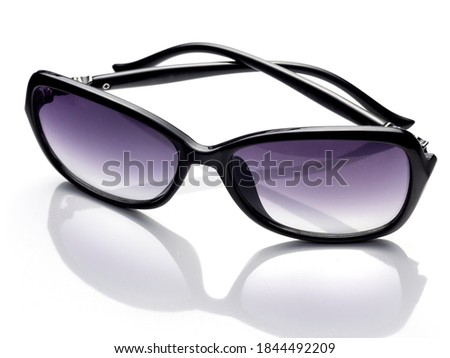 Sunglasses with black frames isolated on white background. Elegant women's sunglasses with purple lens.