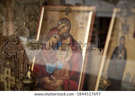 Holy family in a gilded frame in a shop window.