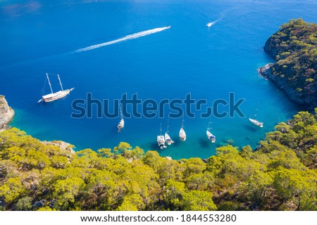 view to lagoon with boats and path of speed boat at the sea