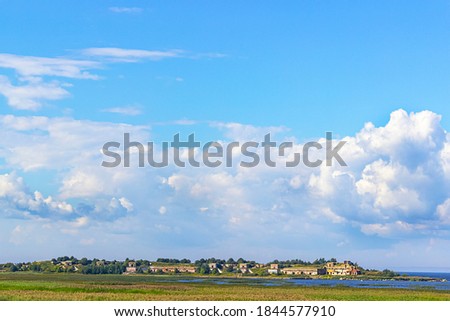 beautiful landscape photo with the ruins of an ancient Fort in the city of Saint Petersburg. warm summer colors. Green field and blue sky with clouds.