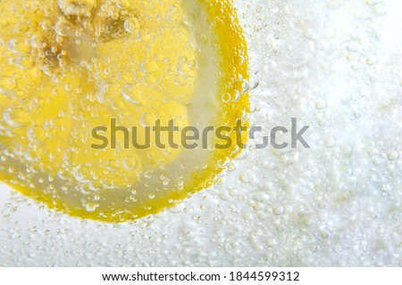 Detail of carbonated water with lemon wedge inside close up Royalty-Free Stock Photo #1844599312