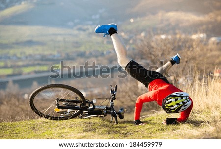 Mountain Biker has a painful looking crash with his bike Royalty-Free Stock Photo #184459979