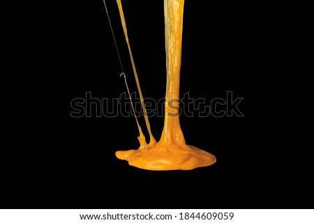 Stretching cheese isolated on black background. Ingredient preparation for design. Melting cheese. Royalty-Free Stock Photo #1844609059