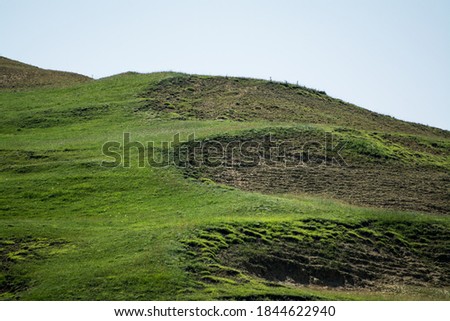 National park reservation. Hiking trail route in the mountains. Walking trail footway. Beautiful meadow. Adventure concept.  Mountain road goes on top of the hills on sunset landscape. 