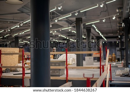 Construction site inside of a big building. Reconstruction of a shop or office space. Royalty-Free Stock Photo #1844638267