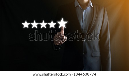 Businessman rating a virtual service with five stars.Increase ranking and rating.For positive customer feedback and review with excellent performance.