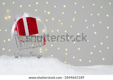 Christmas sales. Purchase and delivery of gifts. Trolley with Christmas decorations. Bokeh background