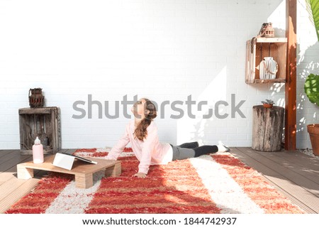 Girl who practices yoga at home. Concept of health.