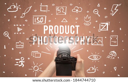 Hand taking picture with digital camera and PRODUCT PHOTOGRAPHY inscription, camera settings concept