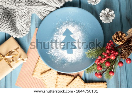 Christmas composition on a wooden background with luminous garlands.