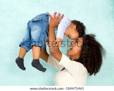 African mother playing with her 11 months old son Royalty-Free Stock Photo #184475465