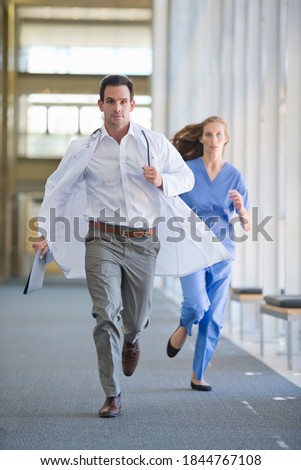 Doctor and nurse running down the hospital corridor