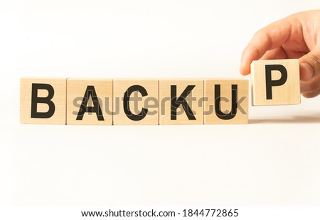 Word backup. Wooden small cubes with letters isolated on white background with copy space available
