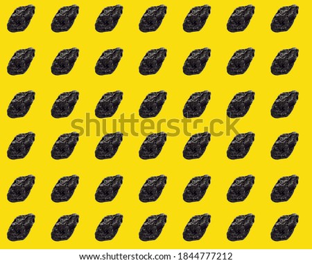 Black prunes on a yellow background