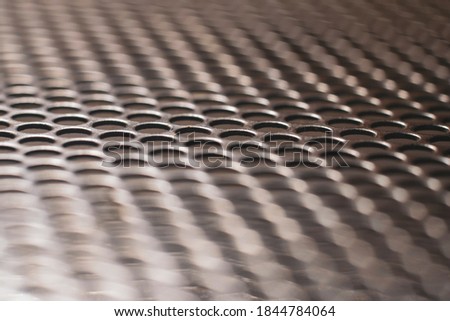 Abstract multicolor perforated metal background. Design element texture