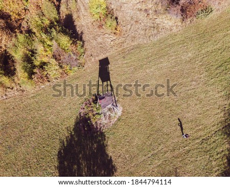 Aerial photo of hunting post and drone pilot with long shadows at the forest clearing on the Japetic mountain, Croatia