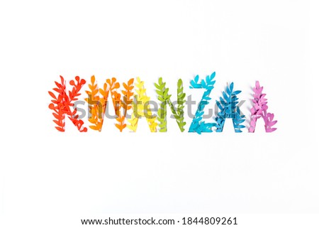 Happy Kwanzaa rainbow Greeting Card Background. Lettering made from paper leaves. Paper art concept.