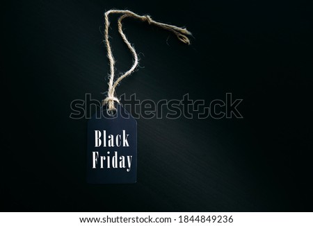 Concept of global shopping. Black Friday in the world. Label on the rope with inscription on black background.