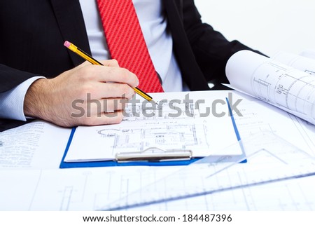 Architect studying some blueprints, closeup shot