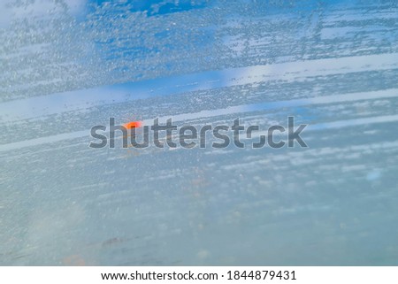 frost on the windshield of the car while driving on the highway. driving danger in poor visibility, front and background blurred with bokeh effect