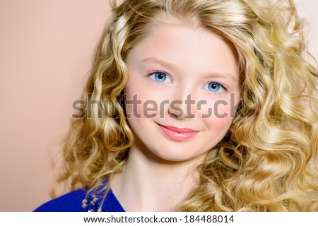 Portrait of a smiling girl with beautiful curly hair.