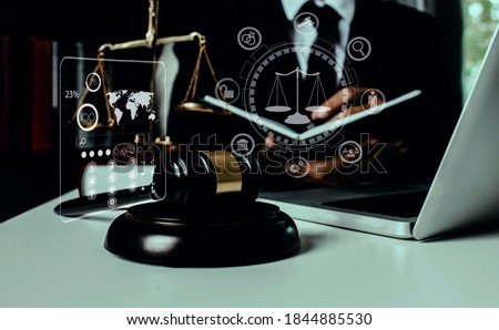 Justice and law concept. Law interface icons, Lawyer business hand working on table office, Blurred background.