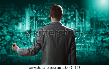 Back view of confident businessman drawing business sketches