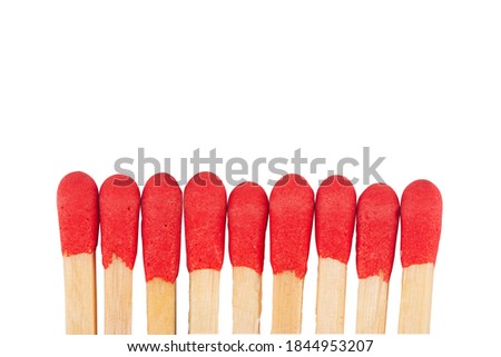 front view macro closeup of red wooden match sticks heads isolated on white background